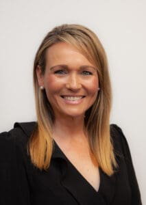 Portrait photo of a woman with long blonde hair smiling